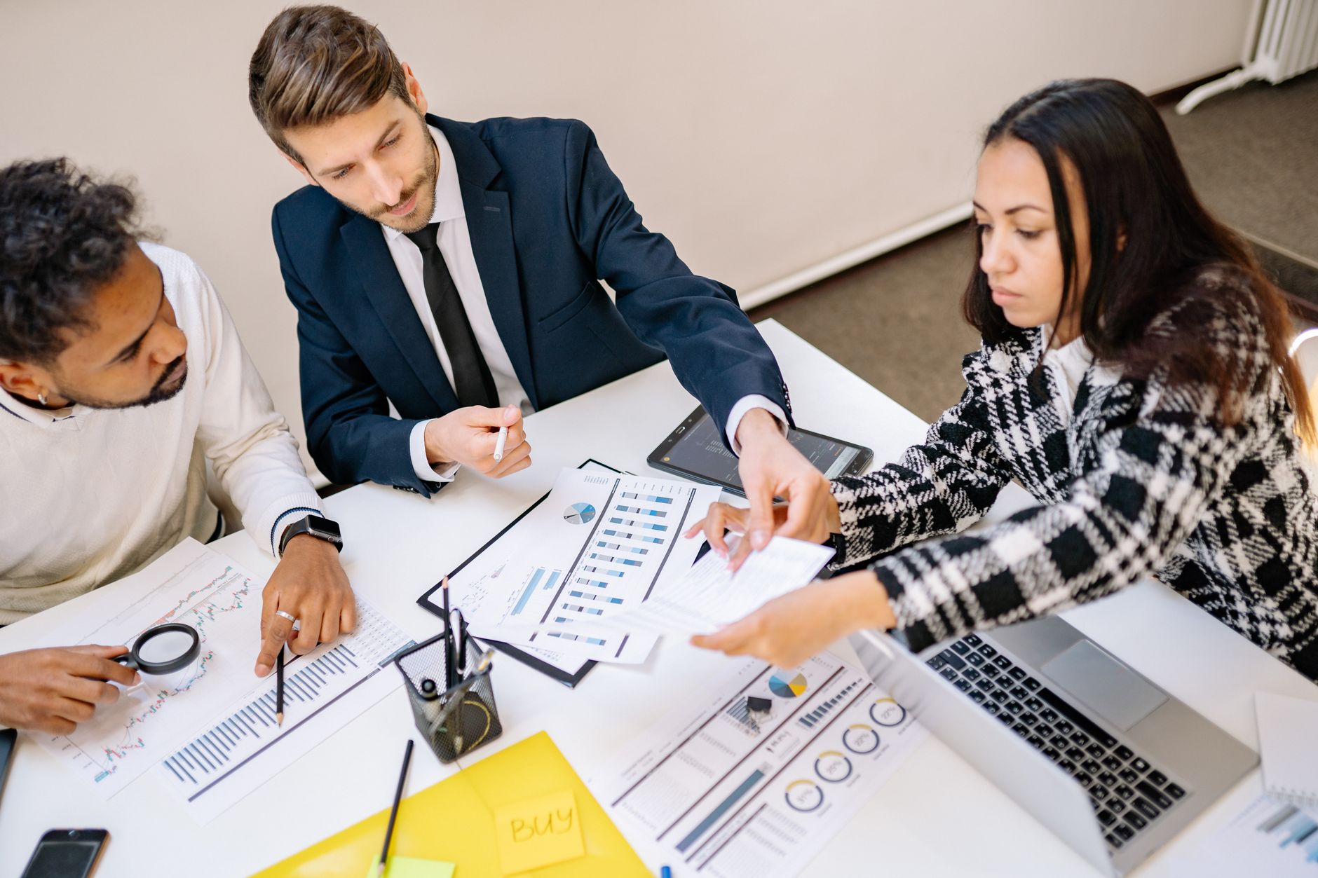 A business team collaborating in a meeting with charts and documents