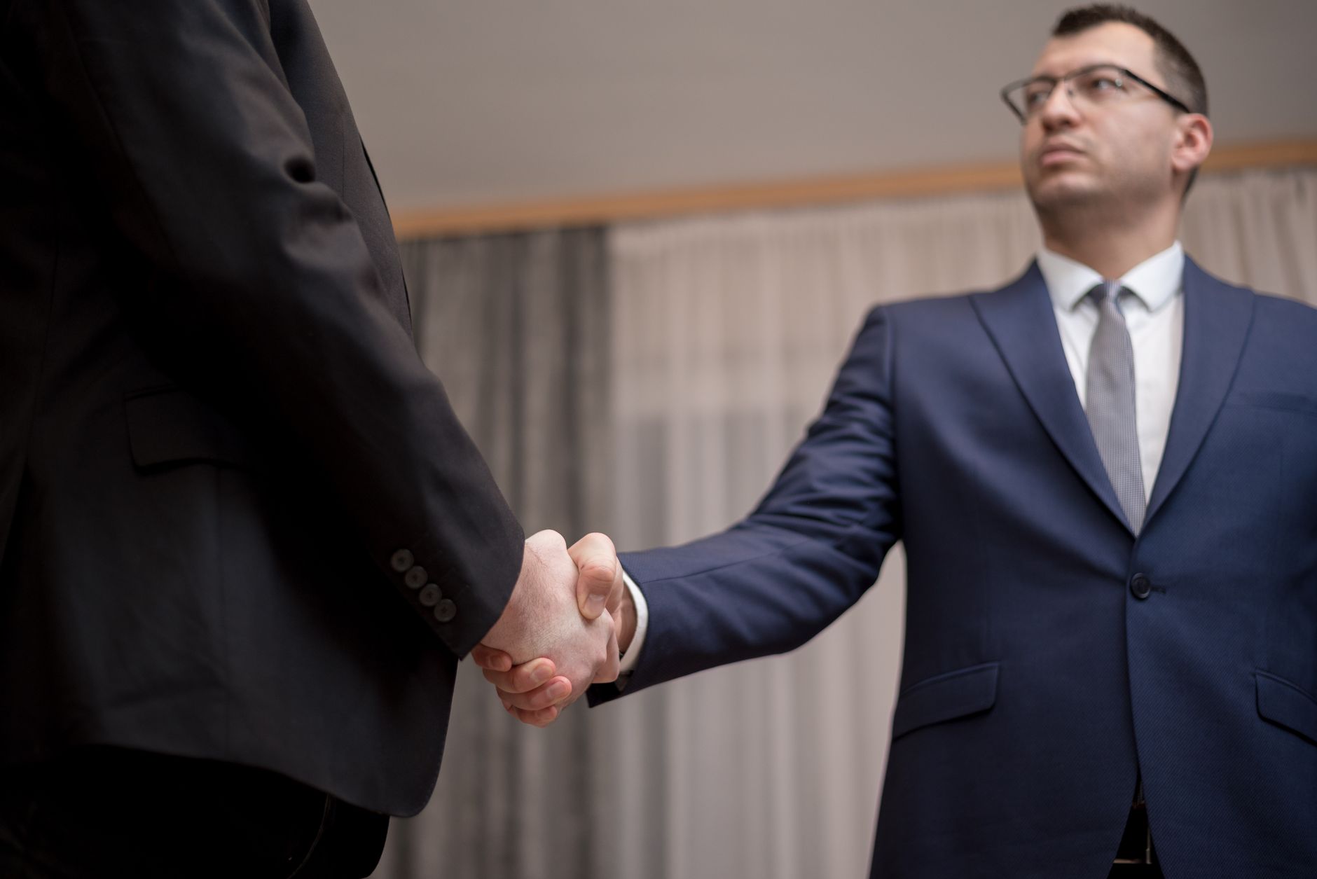 Two business partners shaking hands during a meeting